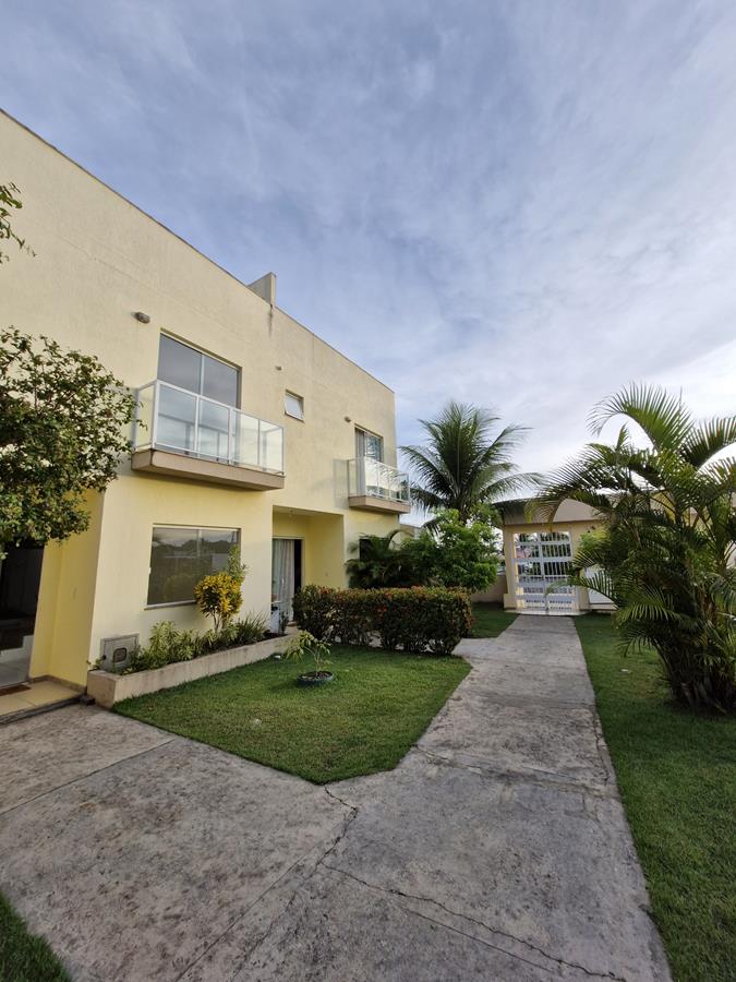 Fachada de village moderno para alugar em Itapuã com jardim frontal